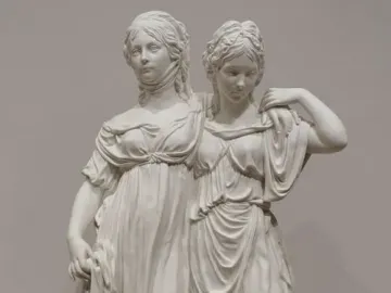 Princesses Monument showing two white classical women in flowing gowns standing together on a base.