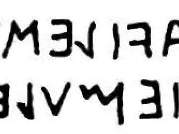 Upside-down inscription on the Stele of Avile Tite, shown as two lines of dark ancient characters on a white background.