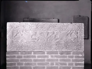 The Plutei of Theodota stone relief with two winged beasts facing a central foliage motif and a patterned border.