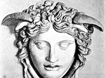 Medusa Rondanini sculpted head with closed eyes and snake-like hair with winged forms at the temples.