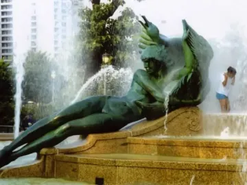 Swann Memorial Fountain with a winged reclining bronze figure spraying water from the multi-tiered basin.