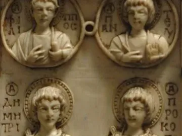 Harbaville Triptych relief carving showing two haloed standing saints holding crosses beneath two busts in round medallions.