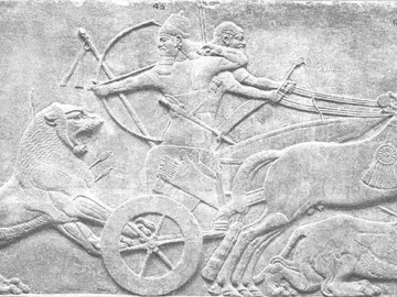 Lion Hunt of Ashurbanipal relief showing a chariot archer shooting at a charging lion, with wounded lions and armed attendants nearby.