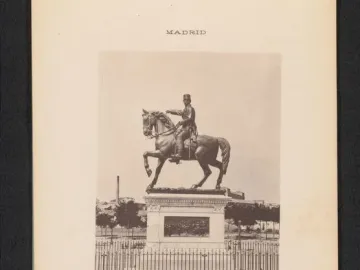 The Marqués del Duero equestrian statue stands on a decorated plinth behind a low iron fence in Madrid.