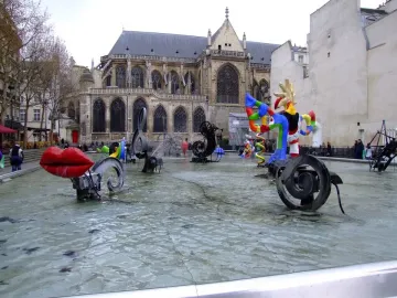 Stravinsky Fountain with colorful abstract sculptures in a shallow basin before the Centre Pompidou in Paris.