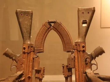 Throne of Weapons sculpture made from rusted gun parts and firearm components.