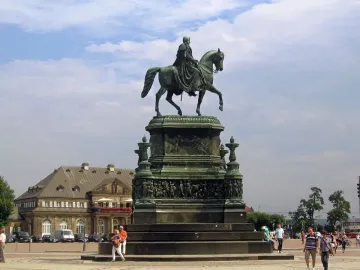 King Johann Memorial bronze equestrian statue on an ornate pedestal in a public square.