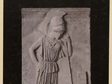 Stone relief of Mourning Athena, showing a helmeted female figure with her head bowed beside a tall marker.