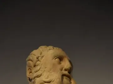 Marble sculpture of the Sacrifice of Isaac showing an older bearded man looking upward.