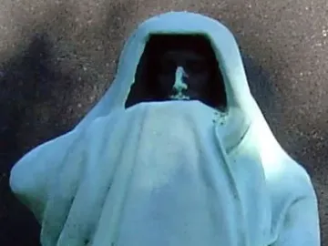Eternal Silence shows a draped hooded figure with its face in shadow and weathered fabric folds.