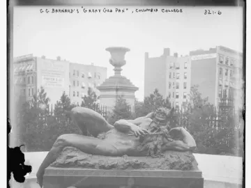 The Great God Pan reclining on a fountain pedestal with lion-head spouts and a tiered pool below.
