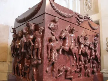 Red porphyry Sarcophagus of Helena carved with mounted soldiers, figures, and garland decoration.