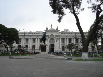 The Equestrian Statue of Simón Bolívar on a tall stone pedestal in front of the Congress of Peru building.