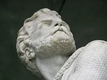 Close-up of the Winkelried Memorial showing a marble head and upper torso of a bearded man with armor on one shoulder.
