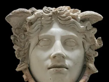 Medusa Rondanini marble head with closed eyes, wavy hair, and snake-like forms around the lower face.