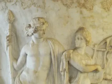 Marble relief from the Borghese Vase showing a nude male figure with a staff beside a draped woman playing a lyre.