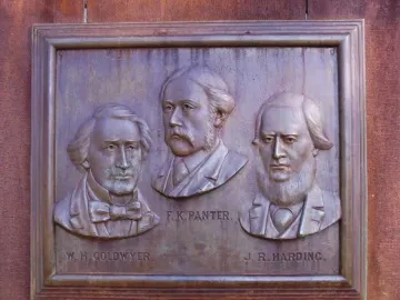 Bronze relief plaque on the Maitland Brown Memorial showing busts of W. H. Goldwyer, F. K. Panter, and J. R. Harding.