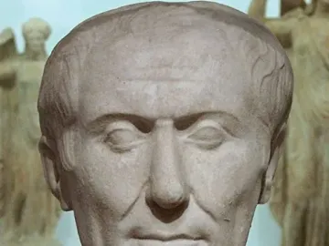 Tusculum portrait of Julius Caesar, a weathered marble bust with a receding hairline and lined face.
