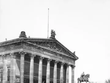 Frederick William IV equestrian statue in front of a classical building with columns and a sculpted frieze.