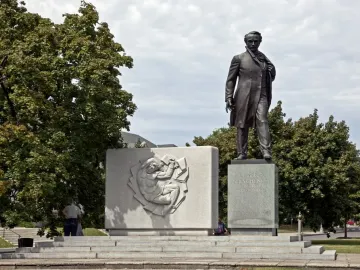 Taras Shevchenko Memorial with a bronze statue beside a relief stele on a tiered stone base.
