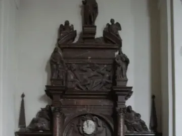 Tomb of Lew Sapieha with a central armored reclining figure and smaller draped figures in a multi-tiered stone monument