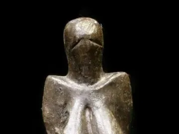 Venus of Dolní Věstonice figurine with a narrow head, prominent breasts, and a tapered body