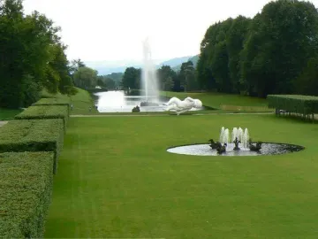 Emperor Fountain with a tall water jet in a park landscape