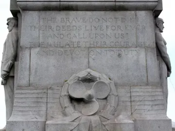 Titanic Engine Room Heroes Memorial inscription with carved male figures and a propeller wreath relief.
