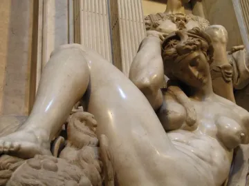 Michelangelo’s Night, a reclining nude marble figure with an owl and mask on the base.