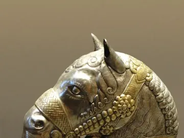 Sassanian horse head sculpture in gilded silver with detailed decorative patterns