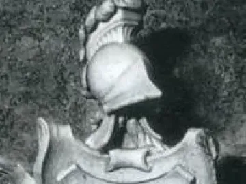 Coat of arms on the Tomb of Ferdinand van den Eynde, with a shield flanked by swan-like figures and topped by a classical helmet crest.