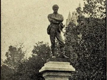 The Appomattox statue shows a man in a military uniform standing with his arms crossed on a tall stone pedestal.