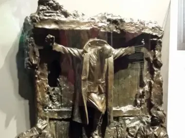 Canada\'s Golgotha bronze sculpture showing a central figure with outstretched arms above several uniformed figures looking up