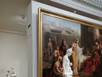 Pandora, a white marble female statue leaning against a pillar with drapery around her lower body
