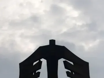 Monument to the Azoreans shown as a dark abstract sculpture with broad horizontal panels and radiating base elements.