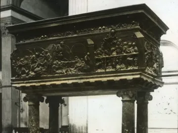 The Resurrection Pulpit, a bronze church pulpit with sculpted reliefs supported by marble columns inside San Lorenzo.