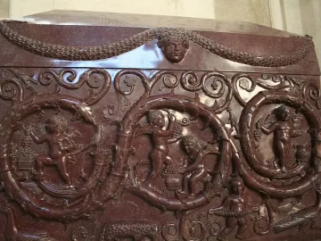 Sarcophagus of Constantina with carved vine scrolls, garlands, and winged figures harvesting grapes.