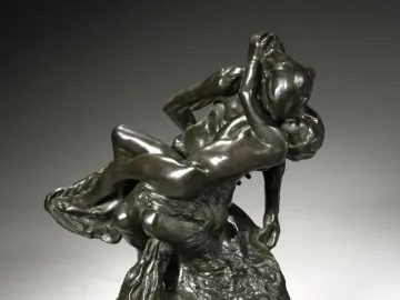 Triumphant Youth, a dark bronze sculpture of two nude muscular figures in a dynamic embrace or struggle.