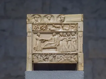 Brescia Casket ivory panel with carved relief scenes in horizontal registers, including busts, animals, and grouped figures.