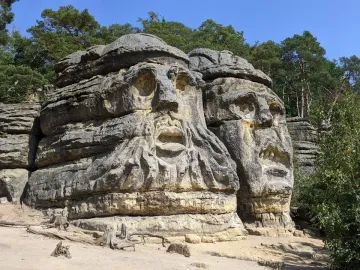 Devil\'s Heads carved into sandstone rock formations beneath a clear blue sky.
