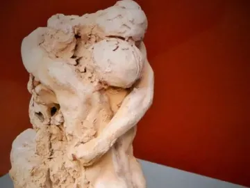 Sakuntala sculpture showing two intertwined figures in an embrace, one leaning over a kneeling figure.