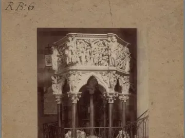 Sant\' Andrea Pulpit with ornate carved relief panels, columns, and supporting figures.