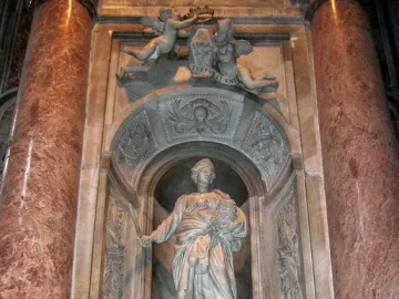 Tomb of Countess Matilda of Tuscany with a standing marble figure in an arched niche, flanked by cherubs and ornate carvings.