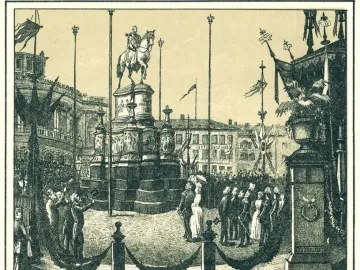 The King Johann Memorial stands on a tiered pedestal in a decorated public square during its unveiling, with a crowd gathered around it.