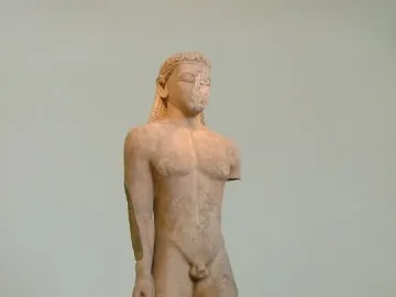 Sounion Kouros, a weathered ancient marble statue of a nude male figure with braided hair and a missing left forearm.