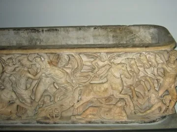 Relief on the Proserpina Sarcophagus showing a mythological kidnapping scene with a woman seized by a man, a chariot, and winged figures.