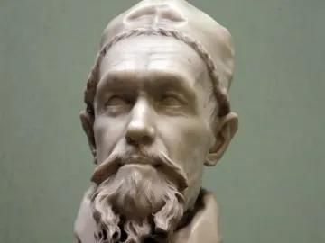 Marble bust of Pope Innocent X with a curly beard, mustache, and clerical cap.