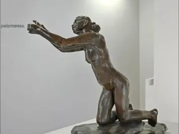 The Implorer bronze sculpture of a nude woman kneeling with outstretched arms.