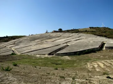 Il Grande Cretto with pale grey concrete slabs broken by deep angular fissures on a hillside