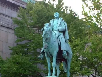 Charles Devens statue, a green-patinaed equestrian monument of a uniformed man on horseback with an inscription on the stone pedestal.